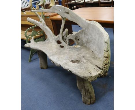 A teak sculptural bench W.175cm