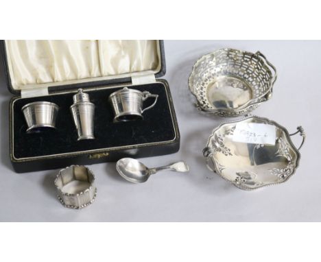 Two pierced silver sweetmeat dishes, a George III silver caddy spoon, silver three piece condiment set and silver napkin ring