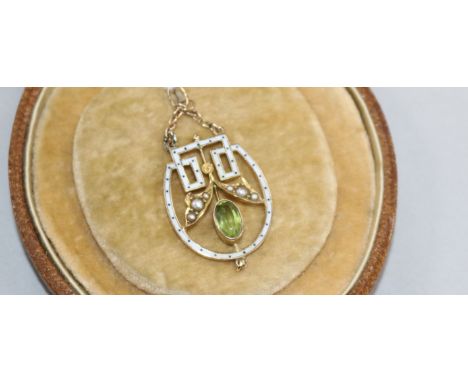 An Edwardian 9ct gold, peridot, seed pearl and white enamel drop pendant, 4cm.