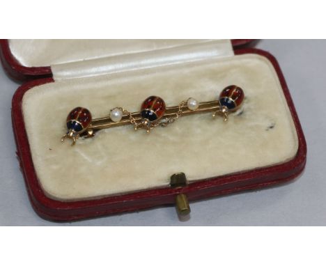 An Edwardian 15ct gold, seed pearl and enamel triple ladybird bar brooch. 43mm.