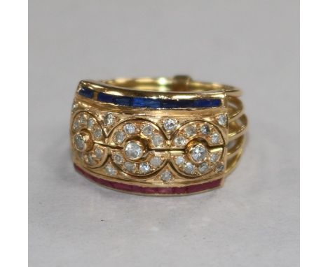 A Middle Eastern yellow metal multi shank ruby, diamond and sapphire 'puzzle' ring, size M.