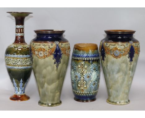 Four items of Doulton Art Nouveau tube-lined stoneware, including a Lambeth jug of barrel form applied with floral motifs and