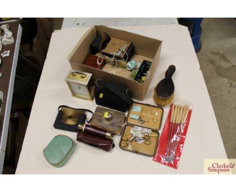 A box of miscellaneous items including a vintage rocker blotter, brushes, mantel clock, boxes etc.