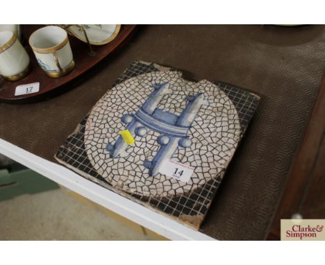 An antique tile with blue stylised decoration