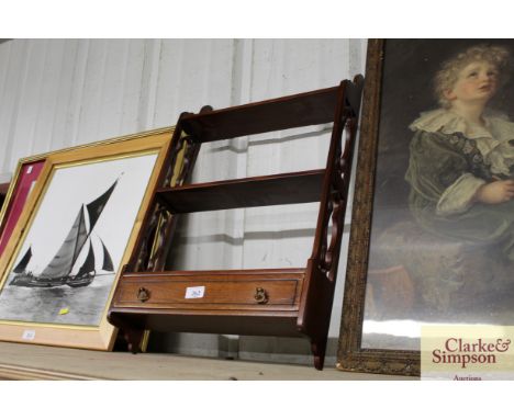 A small mahogany hanging wall shelf fitted single drawer