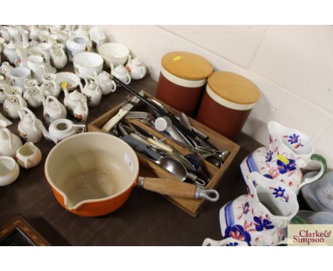 A Le Creuset saucepan; various cutlery contained in a two division cutlery tray; two Hornsea pottery storage jars; and a toas