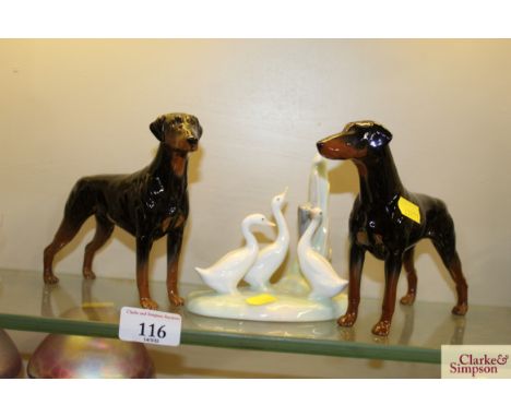 A pair of Beswick figures of Dobermans; and a Nao goose study