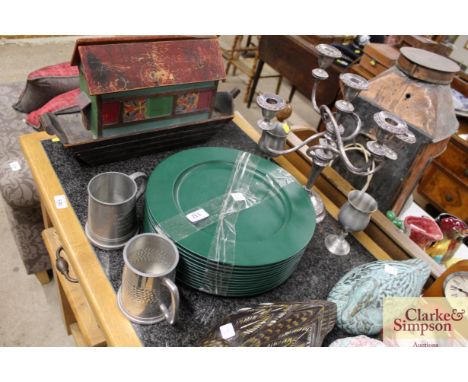 A pewter five light candelabra; a pair of pewter goblets; two pewter mugs; and twelve olive green dinner platters
