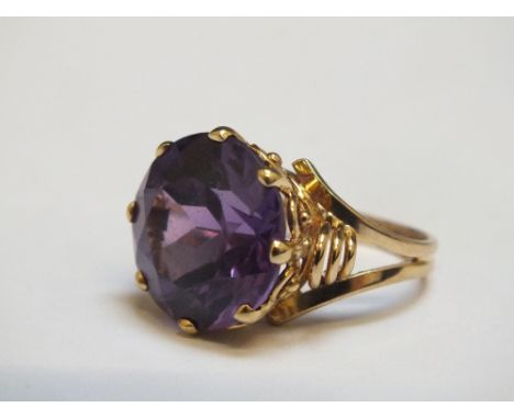 A CONTINENTAL STYLE DRESS RING, marks indistinct, set with a purple stone, approx weight 7.5g, ring size K