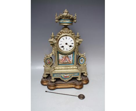 A 19TH CENTURY GILT METAL AND PORCELAIN FRENCH MANTEL CLOCK, of classical outline with urn finial, the porcelain panels paint