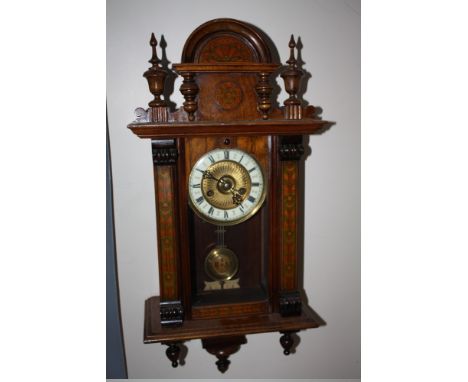 AN ANTIQUE WALNUT CASED VIENNA WALLCLOCK OF SMALL PROPORTIONS, the case decorated with painted floral detail, the enamel and 
