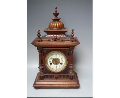 AN EARLY 20TH CENTURY WALNUT 'GREENWICH' MANTEL CLOCK BY W E WATTS, the architectural case topped with a dome and turned fini