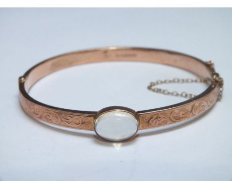 A HALLMARKED 9 CT ROSE GOLD BANGLE, set with a moonstone, approx weight 7.6g