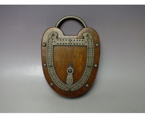 AN UNUSUAL CRIBBAGE BOARD IN THE FORM OF A PADLOCK, the key 'escutcheon' marked Rd. No. 679being a press release to reveal in
