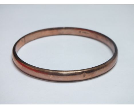 AN ANTIQUE YELLOW METAL BANGLE STAMPED .375, internal Dia.7.5 cm, approx weight 10.4 g