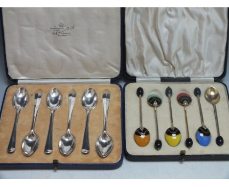 A CASED SET OF SIX ART DECO COFFEE BEAN SPOONS WITH ENAMEL DECORATION,  unmarked gilt metal, together with a set of six silve