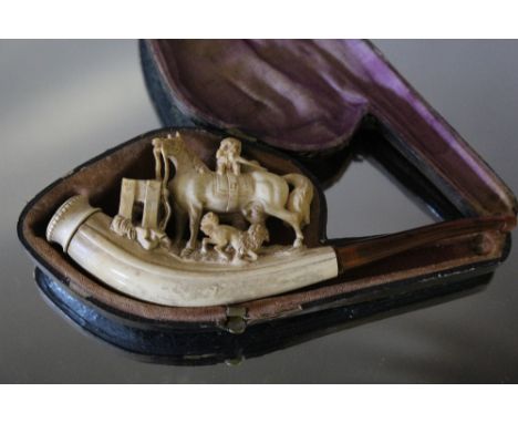 A CARVED MEERSCHAUM PIPE, carved with dogs playing around a horse, W 14.5 cm