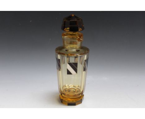 AN ART DECO GLASS DECANTER WITH ENAMEL DECORATION, pale amber coloured faceted body with black and silver enamel panels, comp