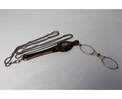 A PAIR OF VICTORIAN YELLOW METAL AND TORTOISESHELL SPRUNG FOLDING LORGNETTES, with attached white metal guard chain