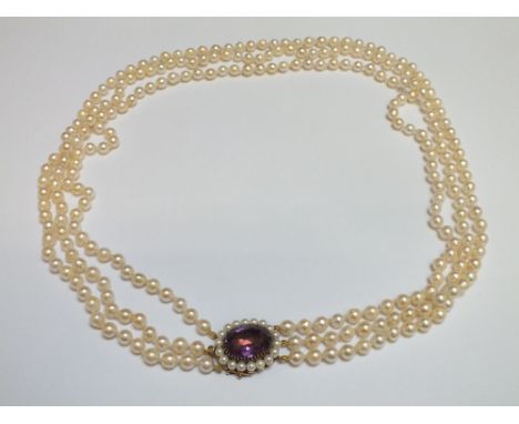 A HALLMARKED 9 CARAT GOLD CLASP TRIPLE ROW OF CULTURED PEARLS WITH LARGE AMETHYST, amethyst measures approx 20 mm x 15 mm