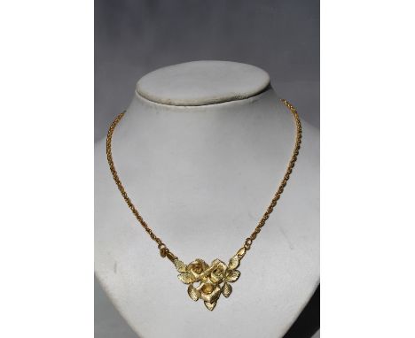 A MATT FINISH THREE ROSE PENDANT, stamped to reverse 750, on an unassociated chain also stamped 750, approx weight 25.6g, pen