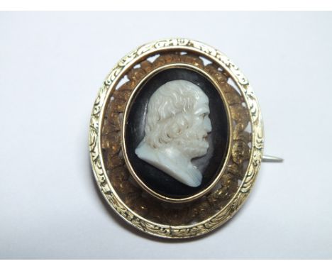 AN UNUSUAL CAMEO BROOCH,  with black enamel type background, unmarked yellow metal, W 2.5 cm