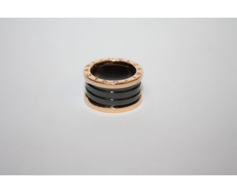 A BVLGARI 18CT ROSE GOLD FOUR BAND RING, the ring with black sprung ceramic spiral design to the centre, ring size L