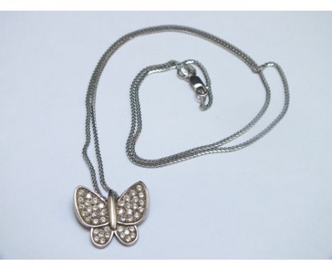 A SMALL MODERN BUTTERFLY PENDANT SET WITH CZ STONES,&nbsp;white metal stamped 585 and on a similar chain stamped 14K, approx 