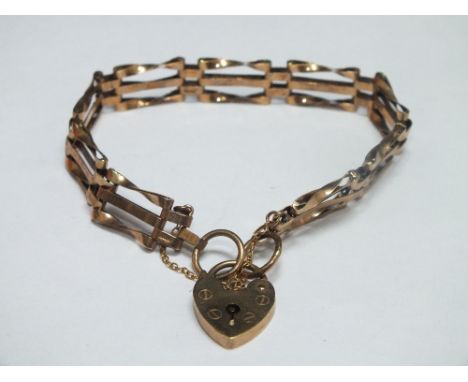 A HALLMARKED 9CT GOLD THREE BAR GATE BRACELET, with heart shaped clasp and safety chain, approx. 8.1g