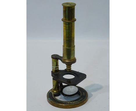 Early C20th century brass monocular microscope with manual focus by J E Winspear of Hull, No. 132, on circular base, H28cm   