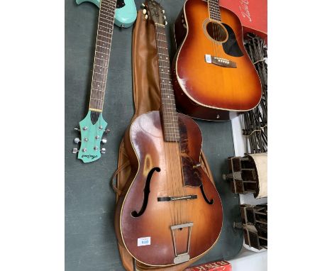 A VINTAGE HOFNER ACOUSTIC GUITAR TOGETHER WITH LEATHER VINTAGE CASE 