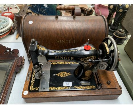 A VINTAGE SINGER SEWING MACHINE WITH WOODEN LID 