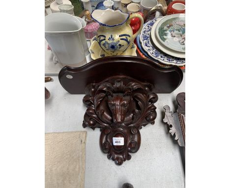 A CARVED LION DESIGN MAHOGANY WALL SHELF 