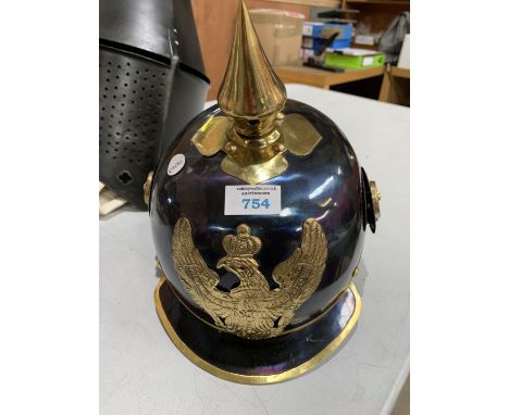 A REPRODUCTION GERMAN ARMY HELMET WITH STAND 
