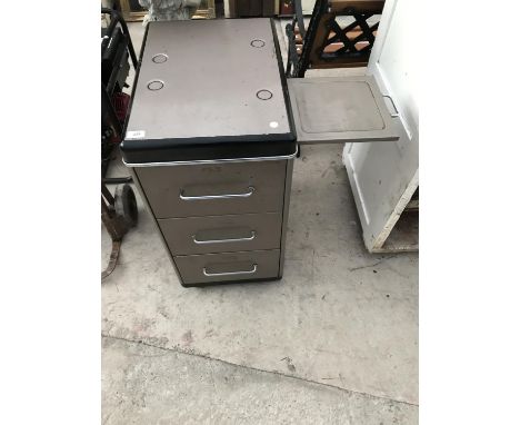 A THREE DRAWER METAL CABINET WITH PULL OUT SHELF 