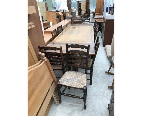 A LARGE OAK DRAW LEAF DINING TABLE AND TEN OAK LADDER BACK DINING CHAIRS WITH RUSH SEATS 