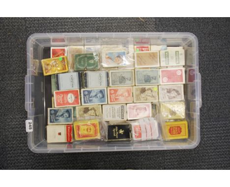 A large collection of vintage packs of playing cards.