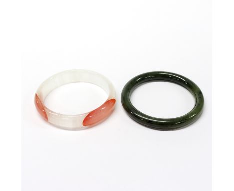 A polished spinach jade bangle with a polished banded agate bangle, internal dia. 6cm.
