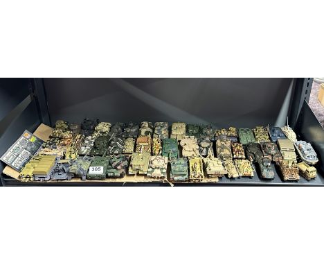 A large group of mixed diecast and plastic model military vehicles.