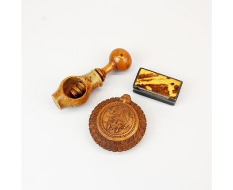 A carved cattle horn snuff box, with an eastern carved wooden snuff box and a turned walnut wood nut cracker (L. 12cm).
