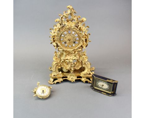 A 19thC French gilt brass mantle clock with enamelled ceramic numerals, H. 33cm. Together with two further small clocks.