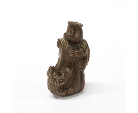 A Japanese carved fruitwood humorous netsuke of a tortoise and a frog with mother of pearl inset signature, H. 6cm.