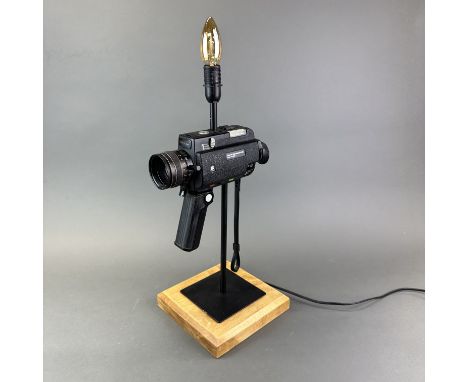 A vintage cine-camera table lamp, H. 57cm.