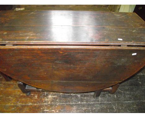 An 18th century oak gateleg dining table of usual form raised on eight turned supports and bobbin mouldings, enclosing a sing