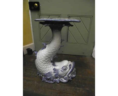A tin glazed ceramic jardiniere stand in the form of a dolphin with raised tail in a white and sea blue painted colourway, 66