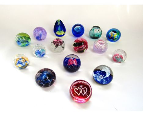 A collection of approximately sixteen 20th century and contemporary Scottish glass paperweights by Caithness with models incl