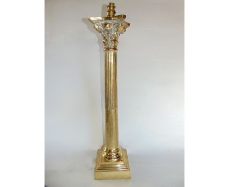 A substantial brass desk lamp in the form of a fluted column with Corinthian capital, raised on a stepped squared base, 68 cm