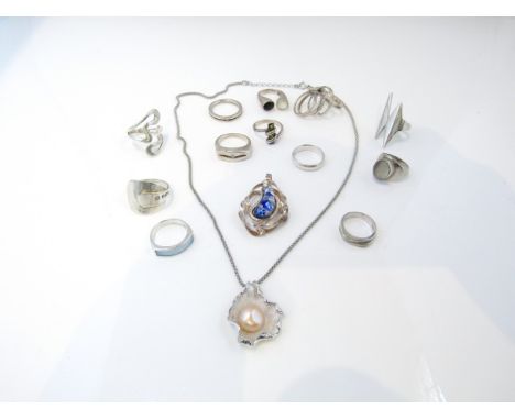 A sterling silver pendant, set with a pearl, on a sterling silver necklace; eleven sterling silver rings, various designs; et