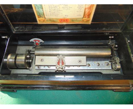 A good quality 19th century timber cased cylinder music box, the exterior with floral inlaid veneers with ebonised border, th