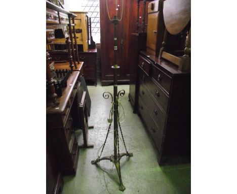 A Victorian brass telescopic oil lamp standard, the tripod supports with lions paw feet (converted to electricity), together 